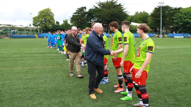 The Radcliffe FC and FC Isle of Man players are greeted by Lieutenant Governor Sir John Lorimer and Steam Packet Managing Director Brian Thomson prior to kick off on Sunday