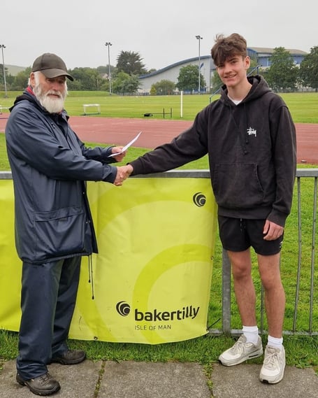 Finlay Taggart being presented with his award by high-jump coach John Whitlow