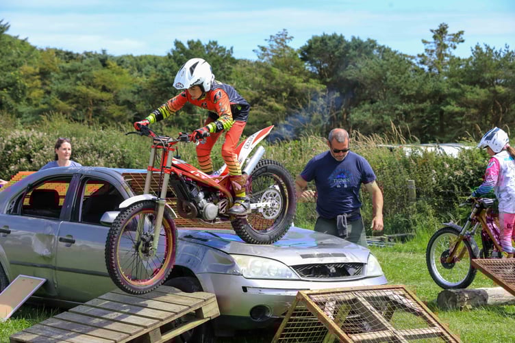 Youngsters take on an obstacle course on their motorbikes