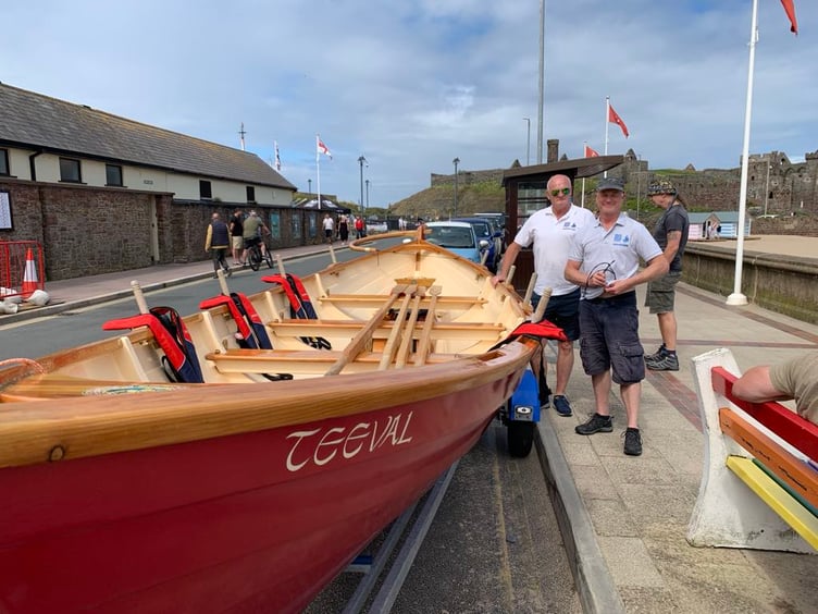 Sea Fest committee members pose with their wooden boat 'Teeval' outside the Yacht Club