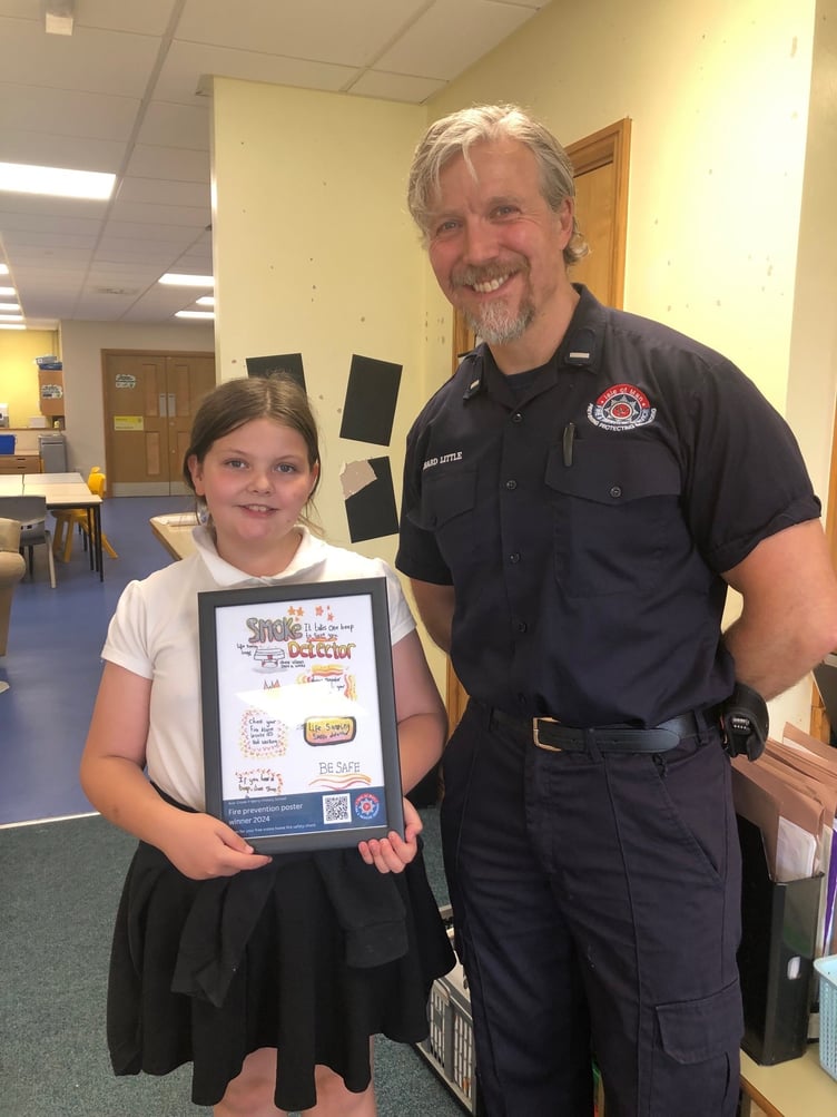 Ava from Cronk-y-Berry primary school with her winning poster