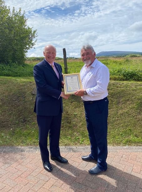 Lieutenant Governor Sir John Lorimer presents the commendation to Ron Berry