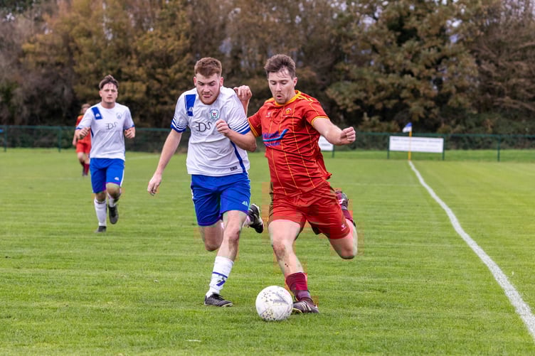 Douglas Royals will be playing football in the DPS Limited Division Two this season, swapping places with Marown.
Pictured is Lucas Watterson (white) and Marown's Connor Gilbert (maroon) when the sides met in February this year at Ballafletcher