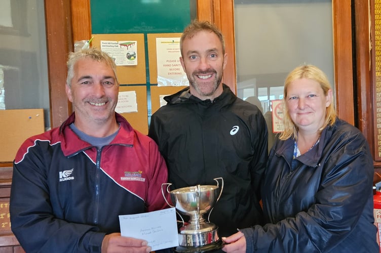 Apollo Blinds Mixed Doubles winners Walter McCarthy (left) and Jayne Smith receive the trophy from Chris Reynolds of competition sponsor Apollo Blinds (Photo: Joyce Ogden) 