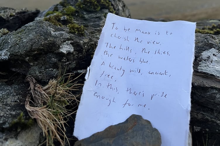 The verse written on a piece of paper at the site of the three legs artwork at North Barrule