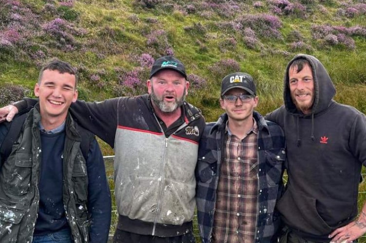 From left to right: Jacob Kelly, Paddy O’Neil, Jake Mayers and Nic Tinnion who repainted the giant three Legs of Man landmark at North Barrule