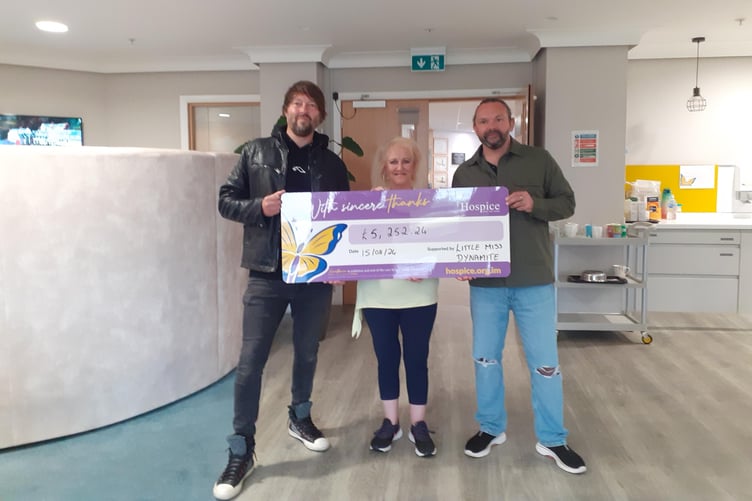 Linda Caulfield, aka Little Miss Dynamite, with the cheque for Hospice raised from her Villa Marina gig. She is pictured with Bahuki band members Rob Millar (left) and Lee Meier who supported her.