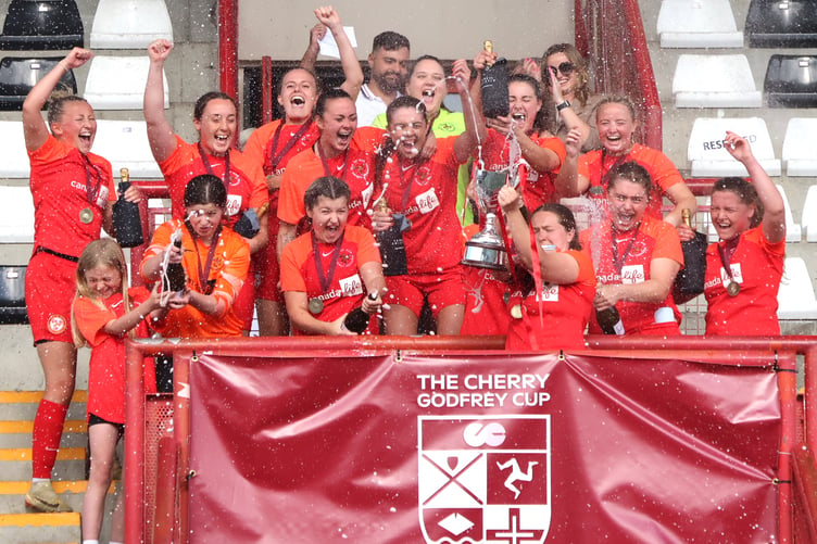 The Isle of Man national women's football team celebrate winning the inaugural Cherry Godfrey Cup in Jersey over the weekend. The Manx side defeated the Isle of Wight in the semi-finals before holding their nerve to beat the hosts on penalties in Saturday’s final - full report on page 45 (Photo: Paul Hatton)