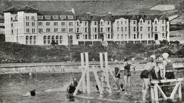 Summer visitors enjoy a trip to Port St Mary beach and its raft, with the Balqueen Hydro in the background