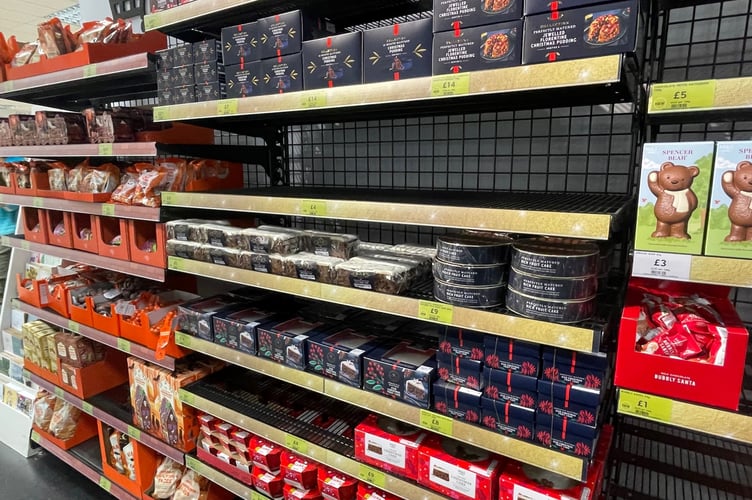 Christmas puddings and other festive items on the shelves of M&S in Douglas