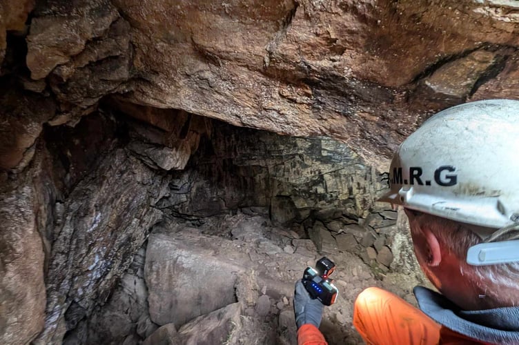 One member of the Laxey Mines Research Group inspecting the sinkhole at the Chasms