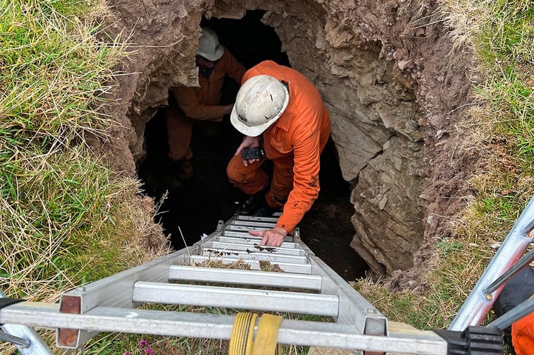 A member of the Laxey Mines Research Group climbs down the Chasms sinkhole