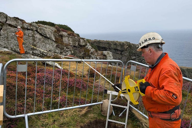 Members of the Laxey Mines Research Group take measurements of the sinkhole at the Chasms