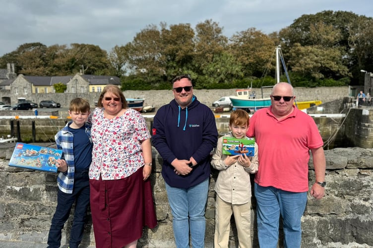 Isle of Man Maritime general manager Captain Lee Clarke with treasure hunt winners the Fargher family in Castletown