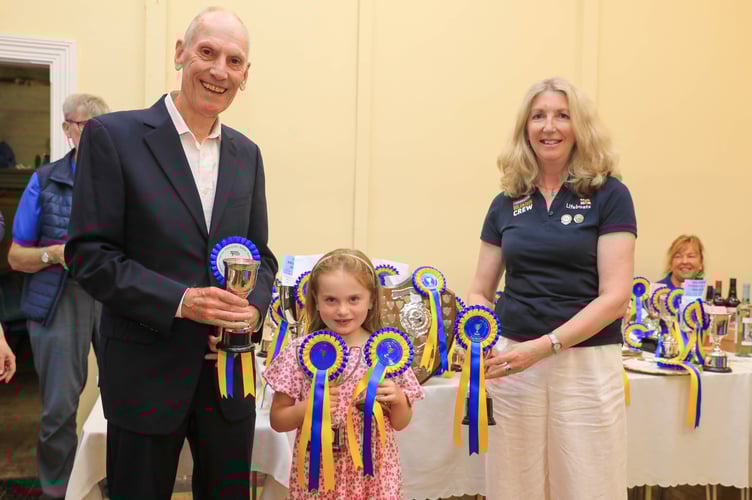 Stuart Lambie (Foxdale Heritage Centre) & Helen Dickinson (Peel RNLI) presenting Amelia Kneen (Middle) with her collection of trophies.