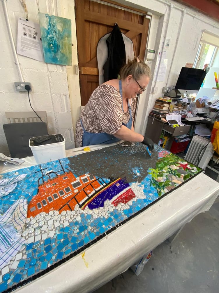 Debra Tracy working on the mosaic