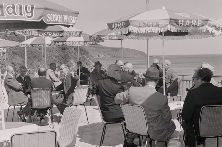 People enjoying a drink at Port Soderick in 1964