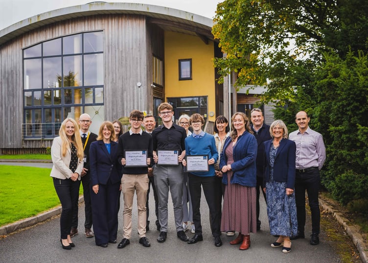 Students with family members, Education Minister Daphne Caine, River Advisers staff and school staff