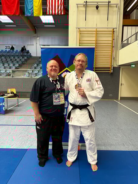 Chris Horton (right) with coach Errol Savage and the bronze medal he won in Germany