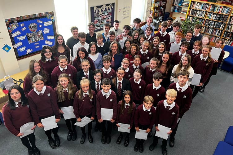 Queen Elizabeth II High School students with Minister of Education Daphne Caine and headteacher Mrs Charlotte Clarke