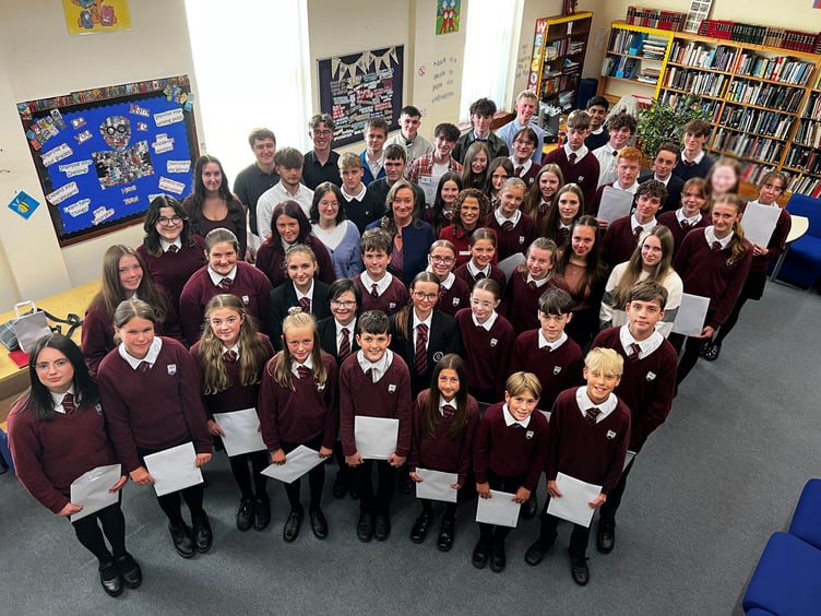 Queen Elizabeth II High School students with Minister of Education Daphne Caine and headteacher Mrs Charlotte Clarke