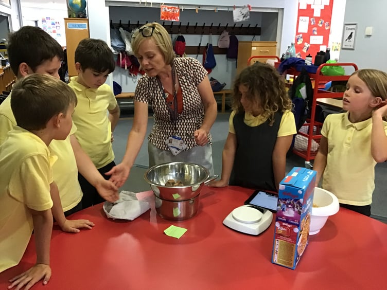 Teacher Mary Jane Douglas with members of Eco-Club making cakes for the Fairtrade cafe