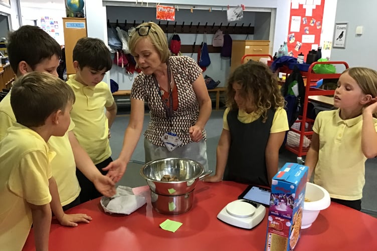 Teacher Mary Jane Douglas with members of Eco-Club making cakes for the Fairtrade cafe