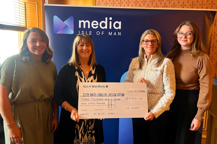Liz Hignett (middle right) with Isle of Man Cancer Association's Sandy Denning. Liz's two daughters are either side
