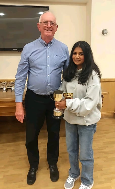 Girls’ 16-and-under competition winner Emma Perera receives her trophy from Castletown Lawn Tennis Club president Ron Ronan