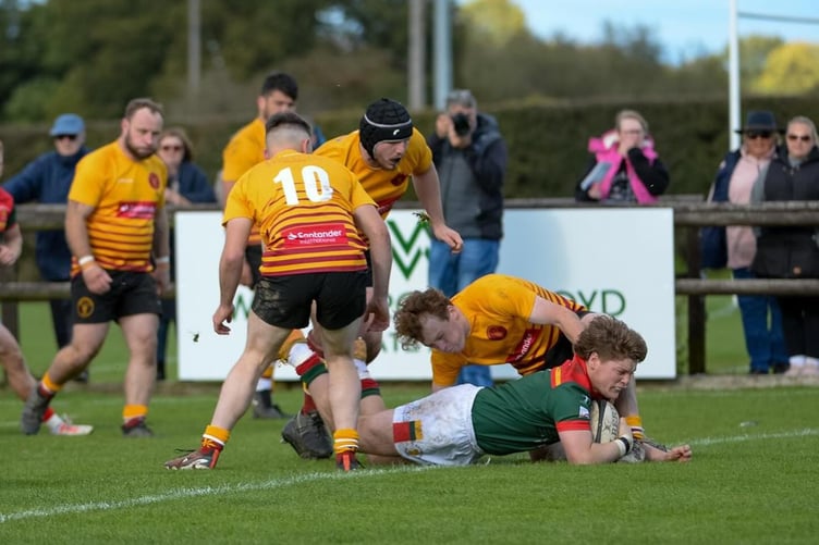 Sandbach’s Josh Brookes scores despite attentions of Kyle Martin, Conor Garland and Nathan Robson (Photo: Paul Cooke)