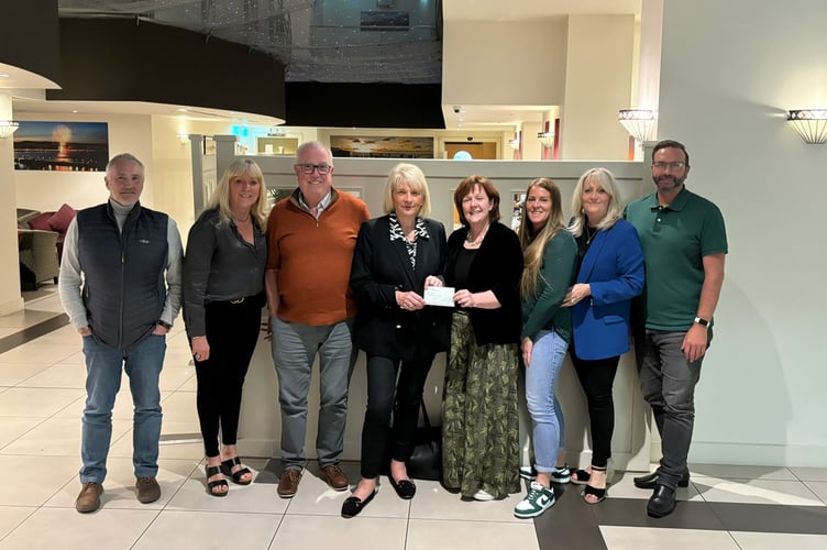 Members of Mind Matters are presented with a cheque by the Manx Breast Cancer Support Group 