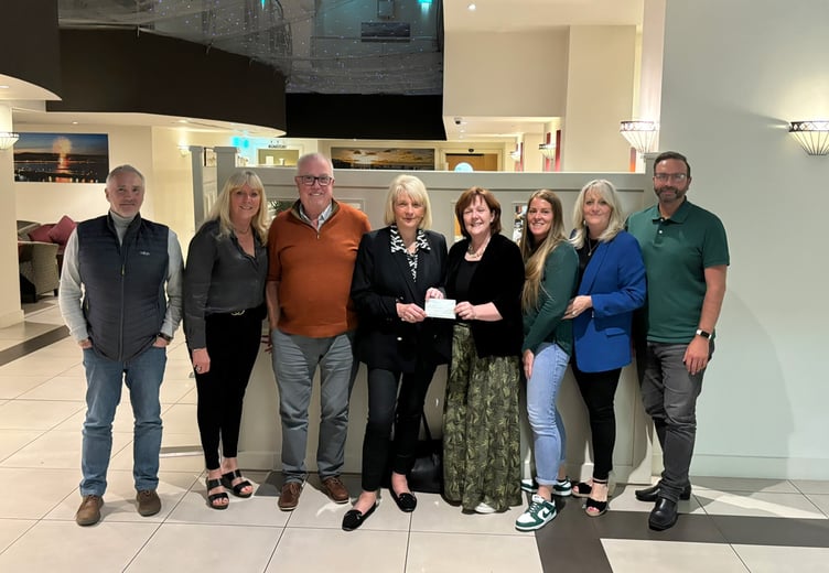 Members of Mind Matters are presented with a cheque by the Manx Breast Cancer Support Group