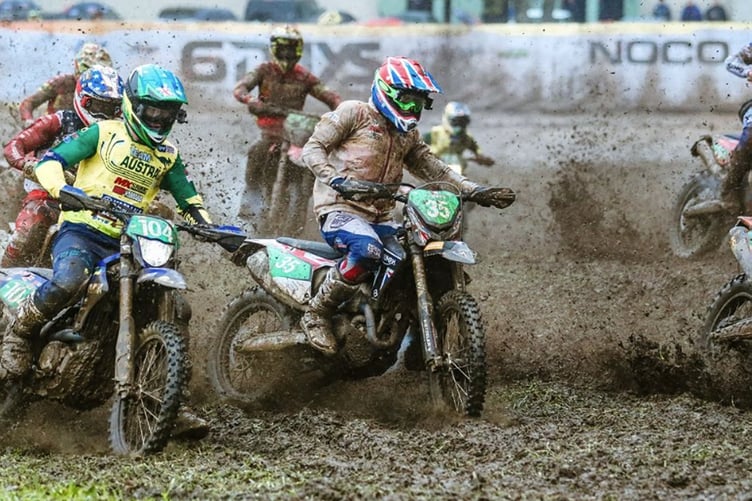 Greeba's Max Ingham (right) tackles the muddy terrain aboard his 250cc four-stroke Triumph machine during the motocross on the final day of the 2024 ISDE in Spain (Photo: ISDE Team GB)