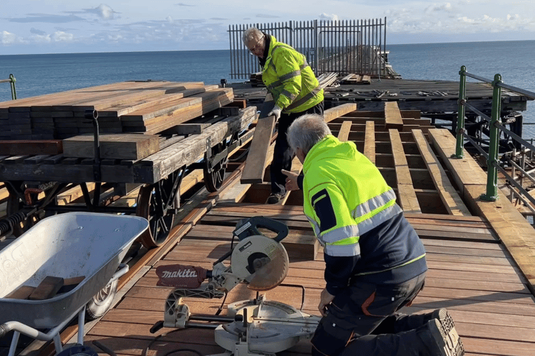 Volunteers busy laying planks on bay 8 of Queen's Pier