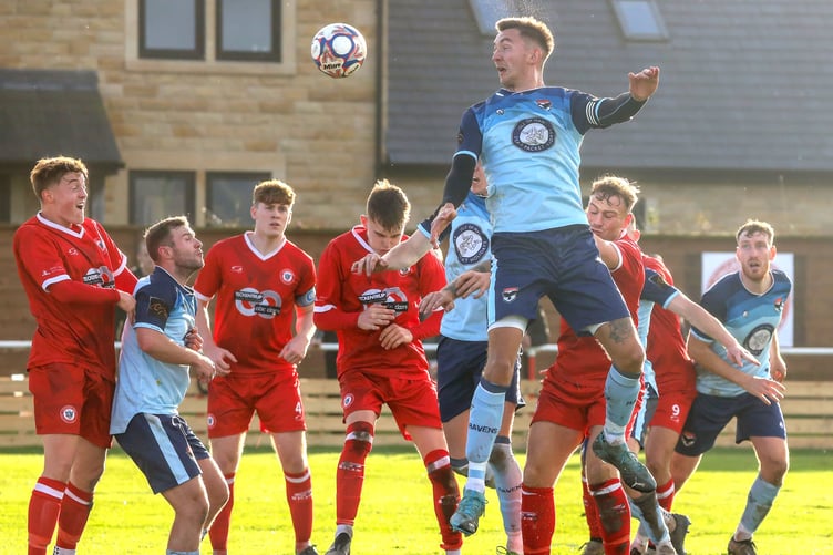 FC Isle of Man captain Sean Doyle rises highest to head goalwards during the Ravens' victory at Longridge Town on Saturday (Photo: Hannah McHugh)