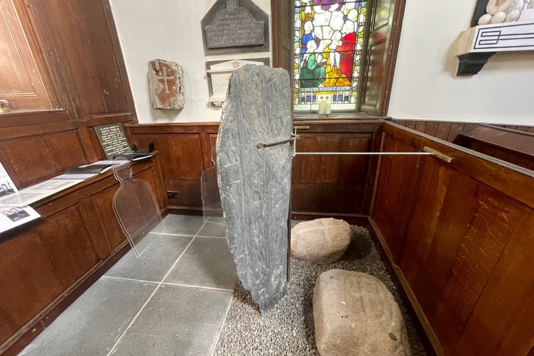 An ancient stone with carvings at Malew Church near Castletown