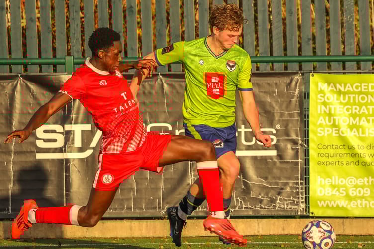 FC Isle of Man winger Dean Pinnington (right) is challenged by a Chadderton opponent during Saturday's Premier Division clash. The Ravens came from a goal down to win 1-2 (Photo: Hannah McHugh)