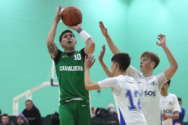 Cavaliers' Rich Gleig releases a jump shot over the top of the defence of Cannons' Samson Shimmin (No.12) and Jack Wilkinson during Thursday evening's match-up at the NSC (Photo: Martin Dunne)
