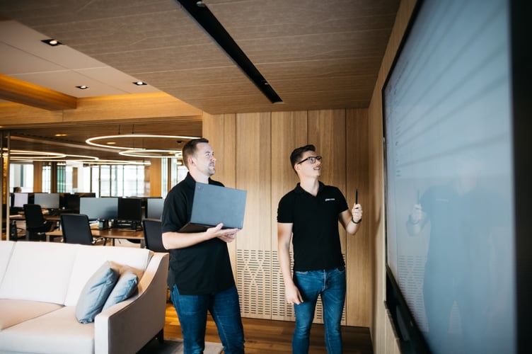 Staff in the meeting area at Plan.com Headquarters on Victoria Street