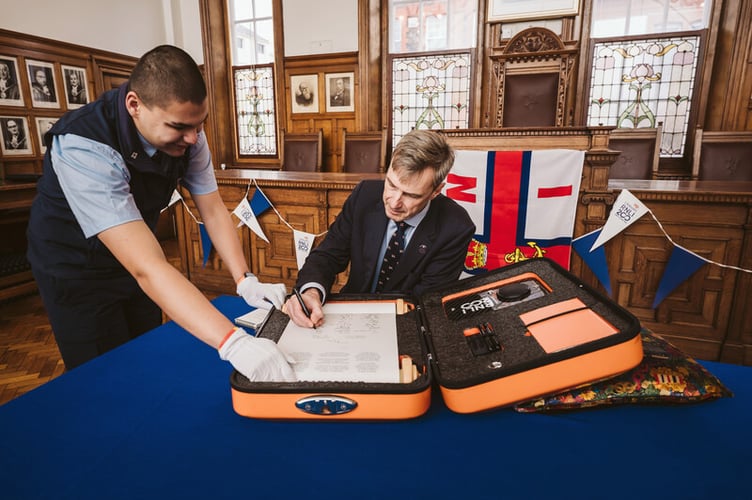 RNLI Chief Executive Peter Sparkes signs the 'Connecting our Communities' scroll at Douglas City Hall
