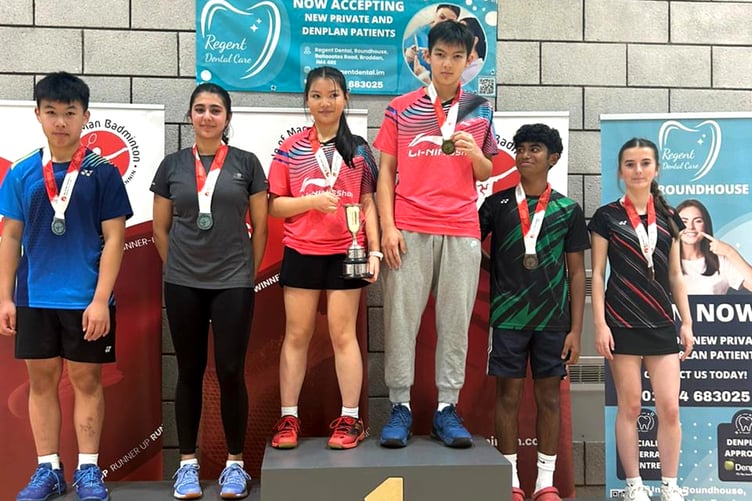 The mixed doubles podium in the Under-17s Island Badminton Championship held at the Roundhouse in Braddan, with Martin and Kelly Cheung on the top step