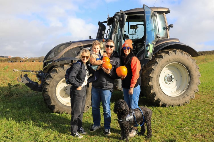 A family pose next to the 'big tractor'
