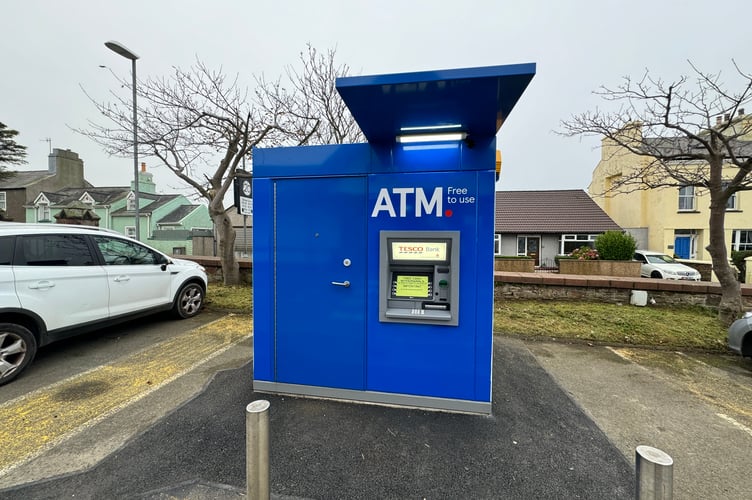 The ATM is opposite the entrance to the Tesco store