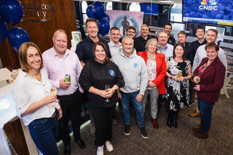 Canaccord's head of wealth management Isle of Man, Tom Richards, with staff at the 20th anniversary celebrations