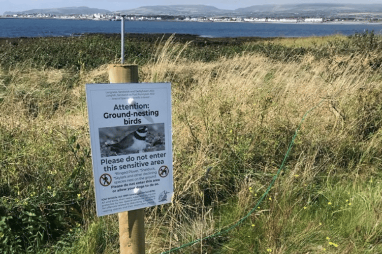 A poster and fence erected at Langness as part of the trial project