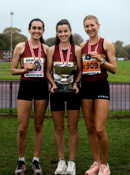 Sarah Astin (centre) holds the impressive English national women's cross-country championship trophy alongside her Belgrave Harriers team-mates Nadine Donegan (left) and Kate Axford (Photo: Graham Smith)