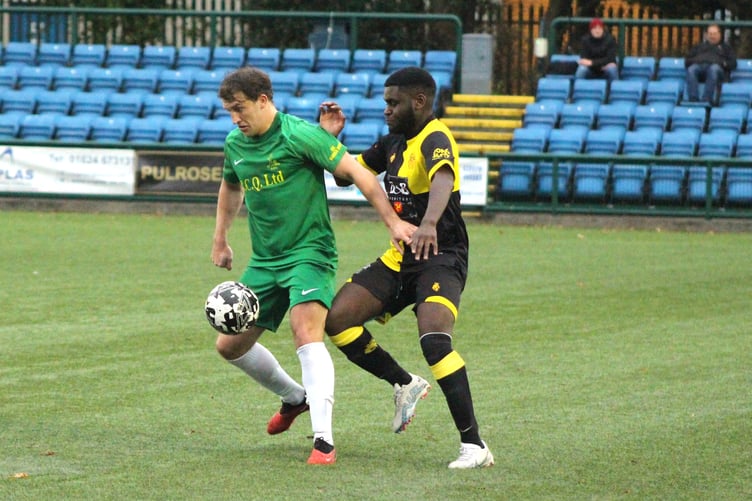 St Mary's midfielder Sammy Gelling (left) attempts to hold off St Georges' Ed Kangah during last weekend's Canada Life Premier League clash at the Bowl (Photo: Megan Dooley)