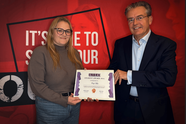 AILO student award winner Paige Killey being presented award from AILO’s chair Jeffrey More