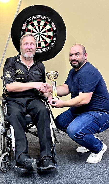 Isle of Man darter Darren Kennish receives the Malta Masters Wheelchair trophy from Roderick Zammit, chairman of the Malta Darts Association