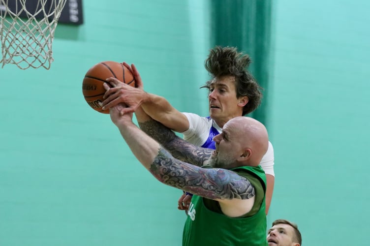 Wolves' Ben Takken fouls Cavaliers' Dave Minay on his way to the basket during the two sides' Senior League clash at the NSC on Thursday (Photo: Oliver Hamilton)